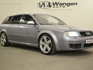 A silver Audi station wagon is parked indoors on a tiled floor, positioned at an angle, with Wangen Auto signage on the wall behind it.